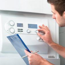 Technician servicing the gas boiler for hot water and heating